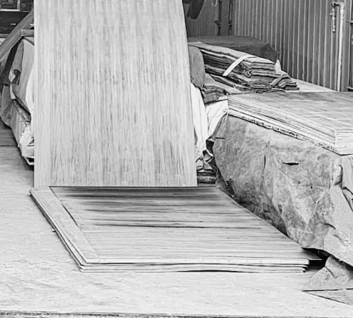 A sheet of veneer leaning on a stack